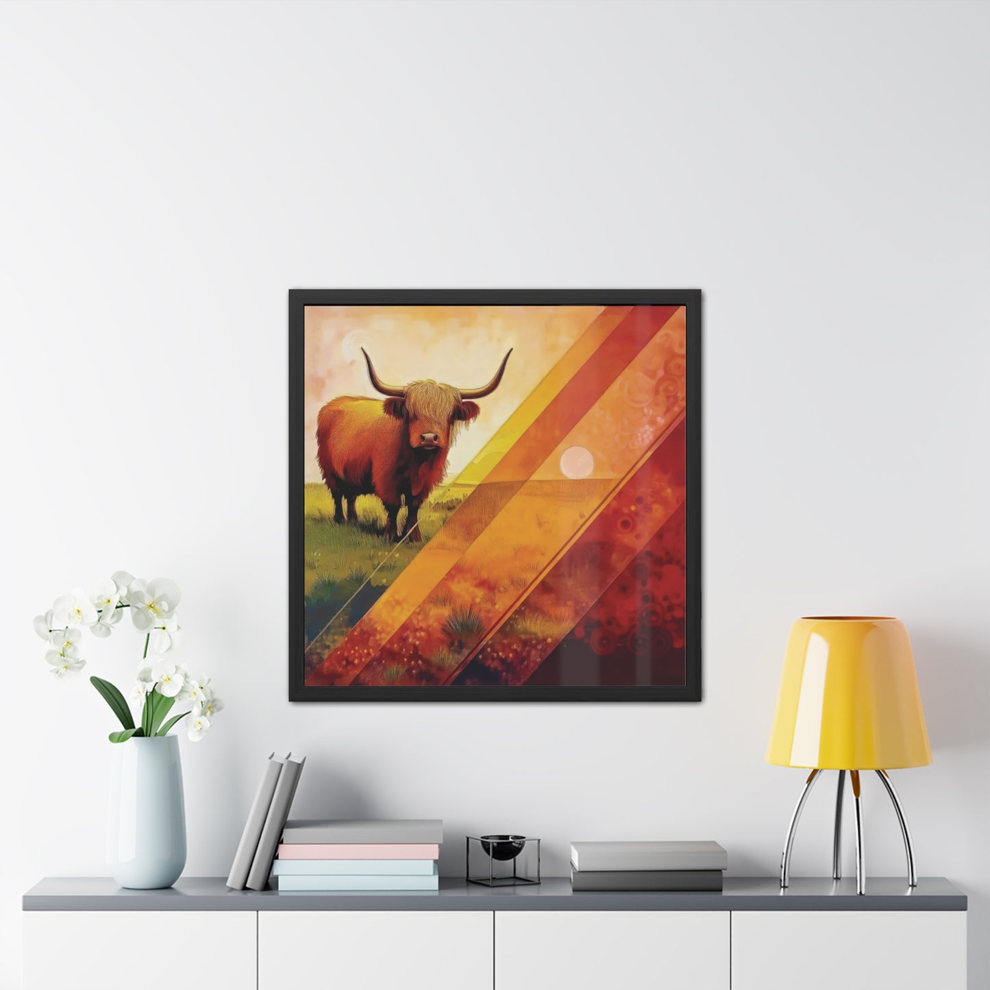 A Highland cow stands on grassy plains, framed by bold orange and yellow geometric patterns. Framed Poster on a white wall.
